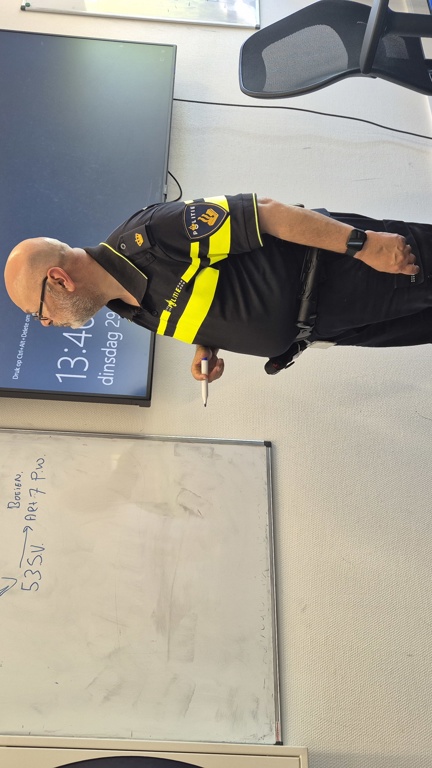 Docent Max staat bij het schoolbord