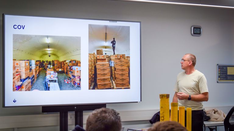 Ferry, the teacher of the fireworks training, is standing in front of the class room