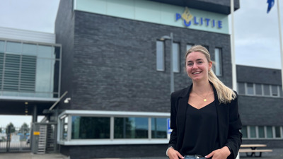 Student Steef staat voor het politiebureau en lacht naar de camera