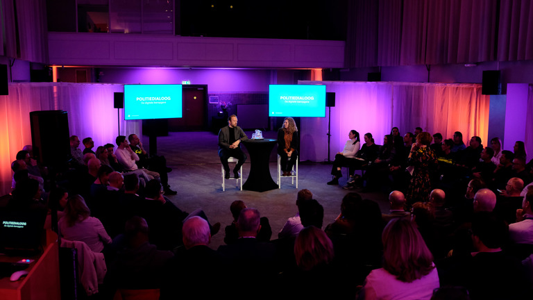 Sprekers temidden van het publiek tijdens de politiedialoog