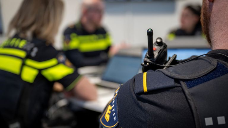 Politiestudenten met elkaar aan tafel met op de voorgrond een epaulet met één streep